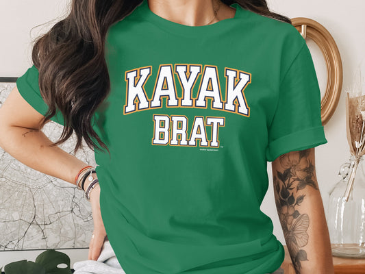Green t-shirt with "KAYAK BRAT" text and "Another Spoiled Brat" logo.