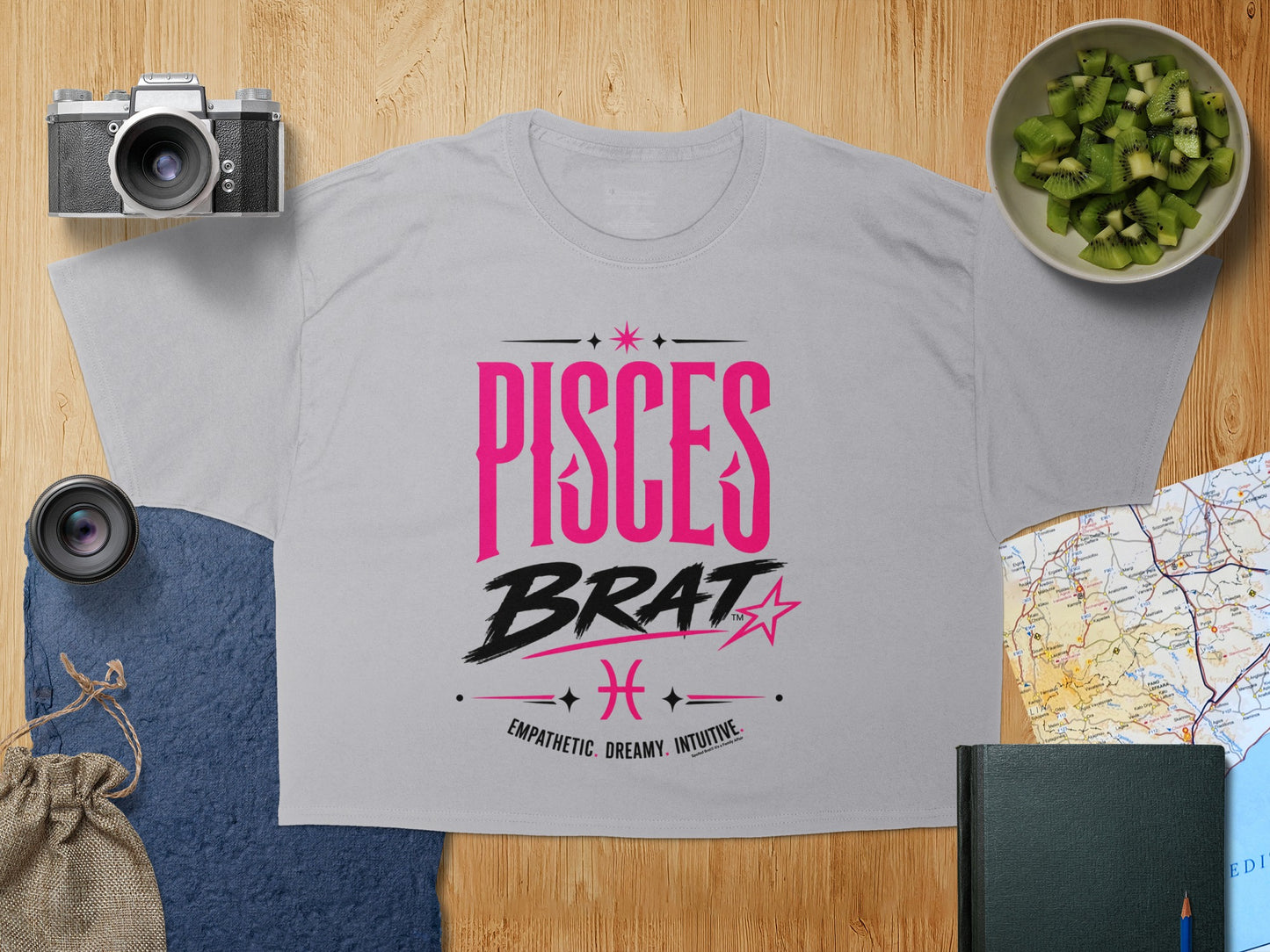 Light gray t-shirt with "PISCES BRAT EMPATHETIC DREAMY INTUITIVE" text.