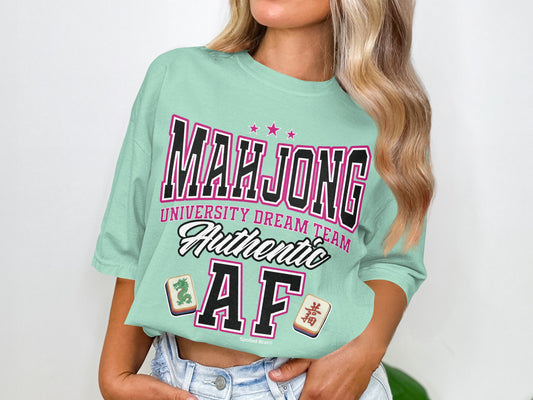 Light teal t-shirt with "Mahjong University Dream Team Authentic AF" text and mahjong tiles.