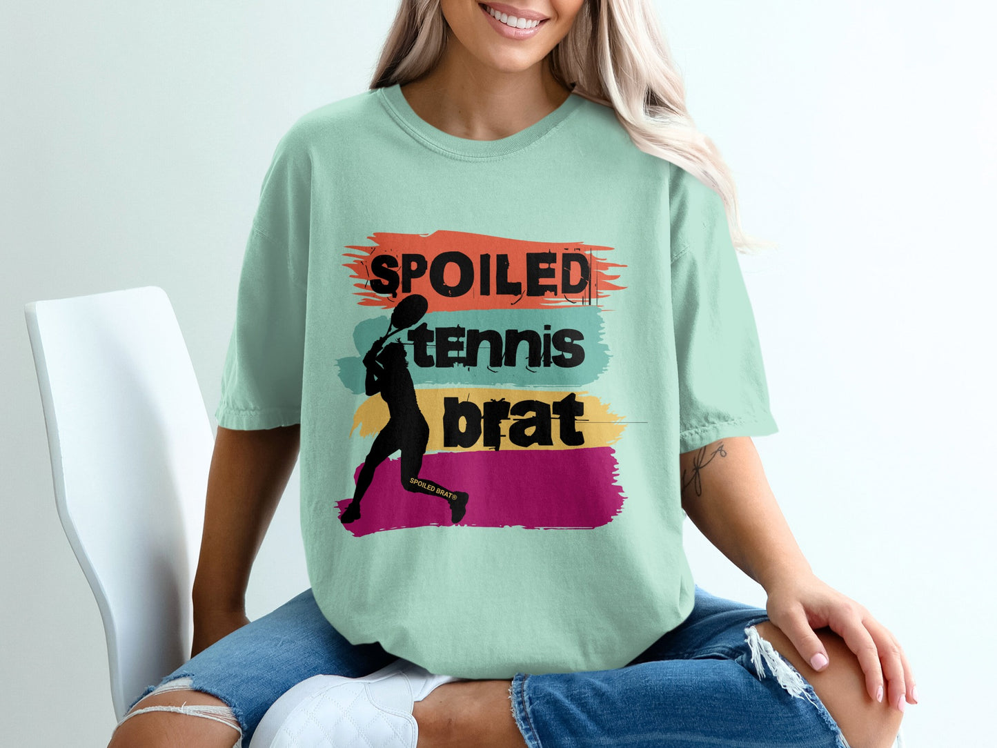 Pale mint t-shirt with colorful stripes and "SPOILED TENNIS BRAT" text.