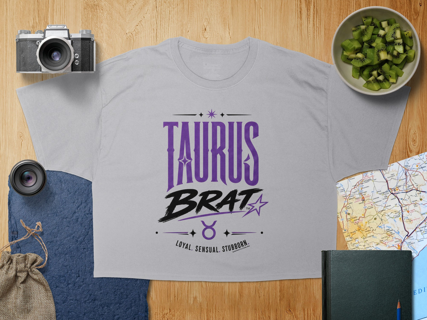 Grey t-shirt with "TAURUS BRAT LOYAL. SENSUAL. STUBBORN." text and Taurus symbol.