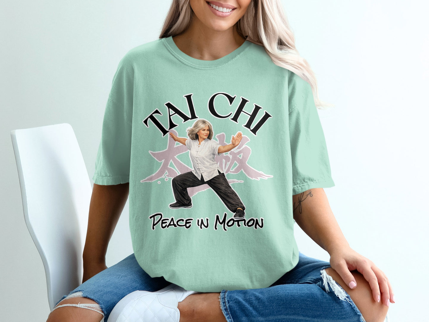 Mint t-shirt with "Tai Chi Peace in Motion" text and woman in martial arts pose.