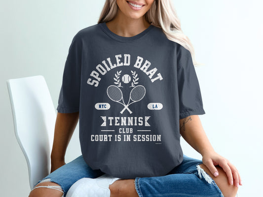 Dark blue t-shirt with "SPOILED BRAT" tennis club graphic and rackets.