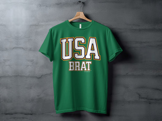 Green t-shirt with "USA BRAT" text on a concrete background.