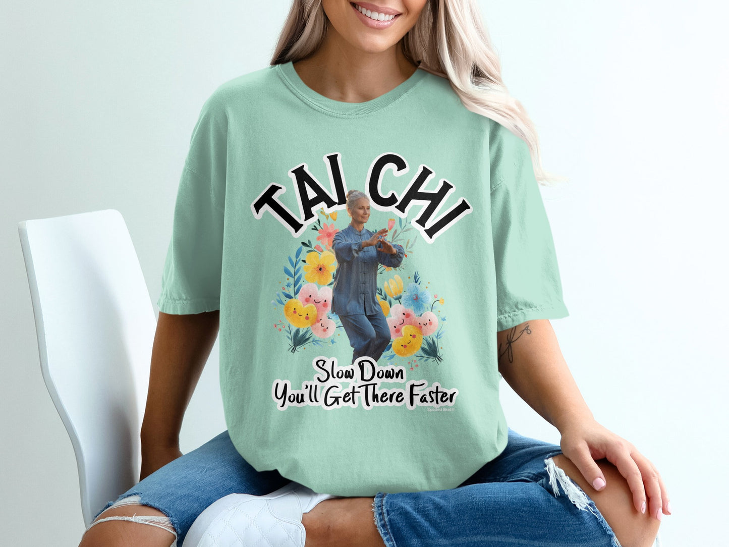 Light green t-shirt with "Tai Chi" and a woman practicing Tai Chi with flowers.