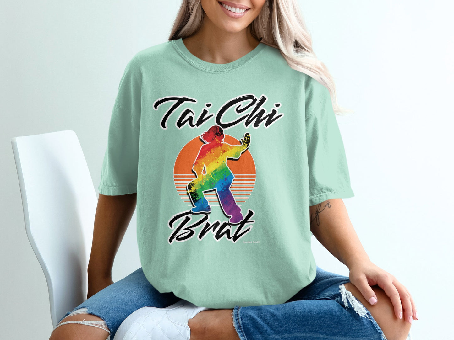 Tai Chi Brat graphic tee with rainbow sunset and person in pose.