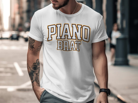 White t-shirt with "PIANO BRAT" text in varsity-style lettering.