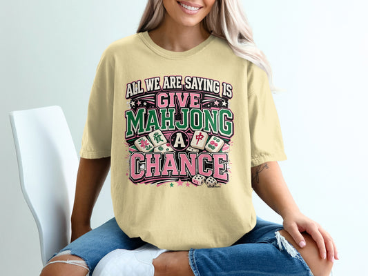 Light yellow t-shirt with "Give Mahjong a Chance" text and dice graphics.