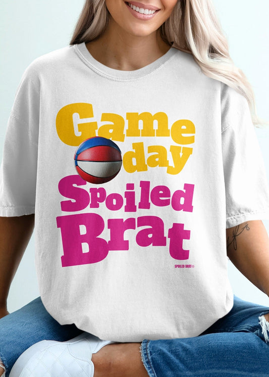 White t-shirt with "Game day Spoiled Brat" text and basketball graphic.
