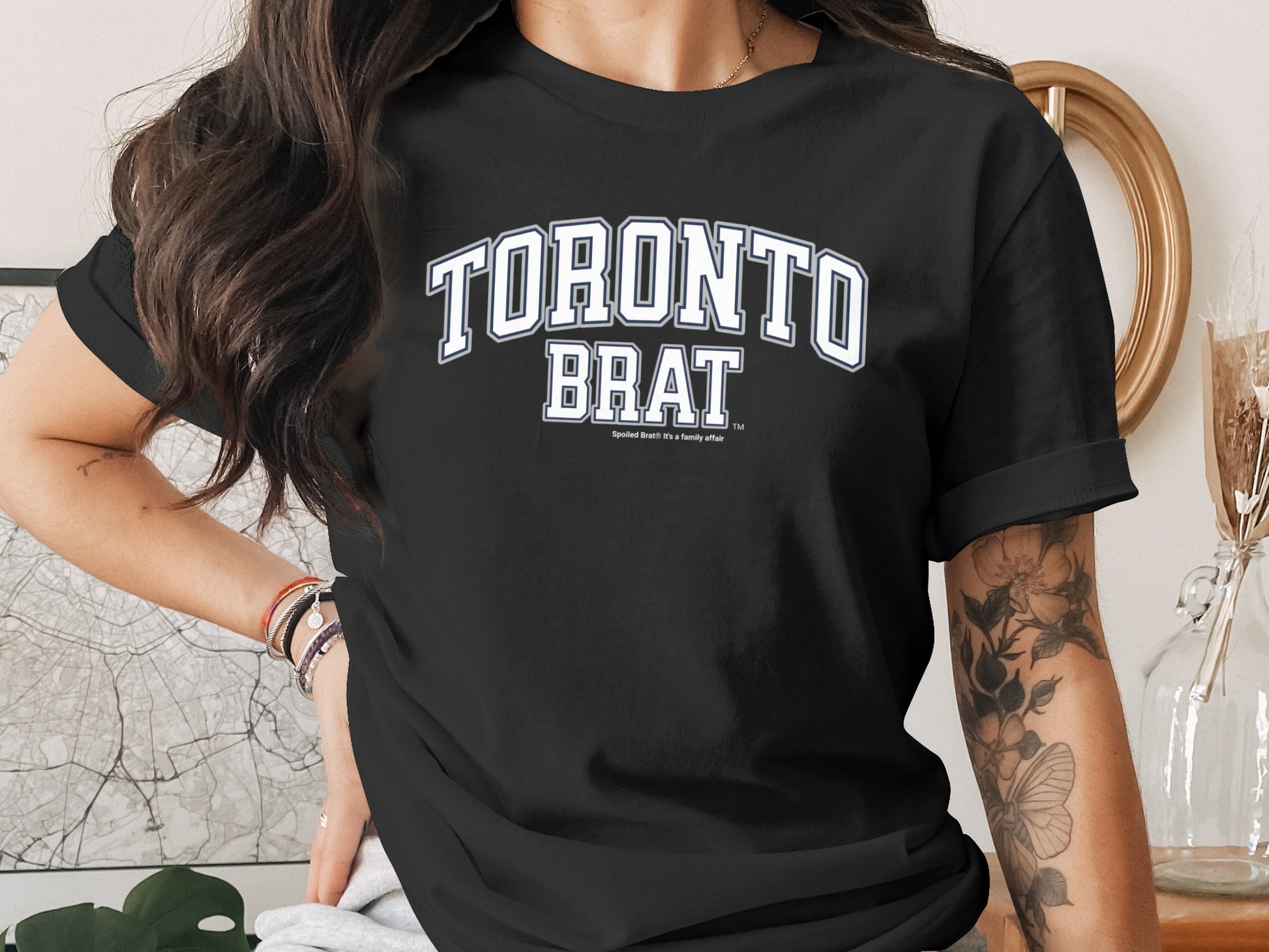 Black t-shirt with "TORONTO BRAT" in white collegiate lettering.