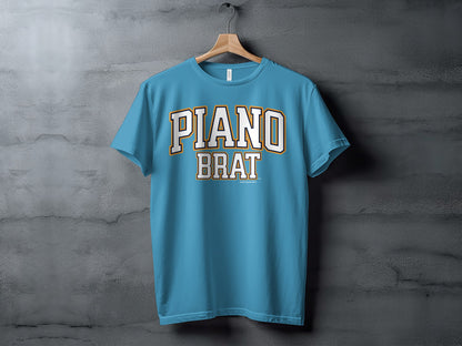 Blue t-shirt with "PIANO BRAT" text in white and orange collegiate font.