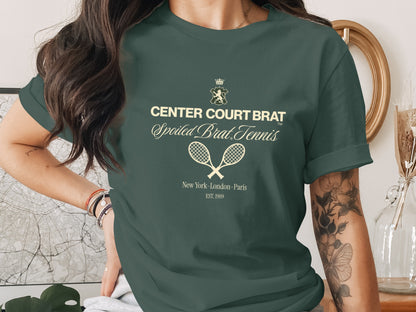 Green t-shirt with text "CENTER COURT BRAT" and tennis rackets.
