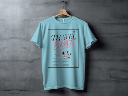 Light blue t-shirt with "TRAVEL BRAT" text and list of cities.