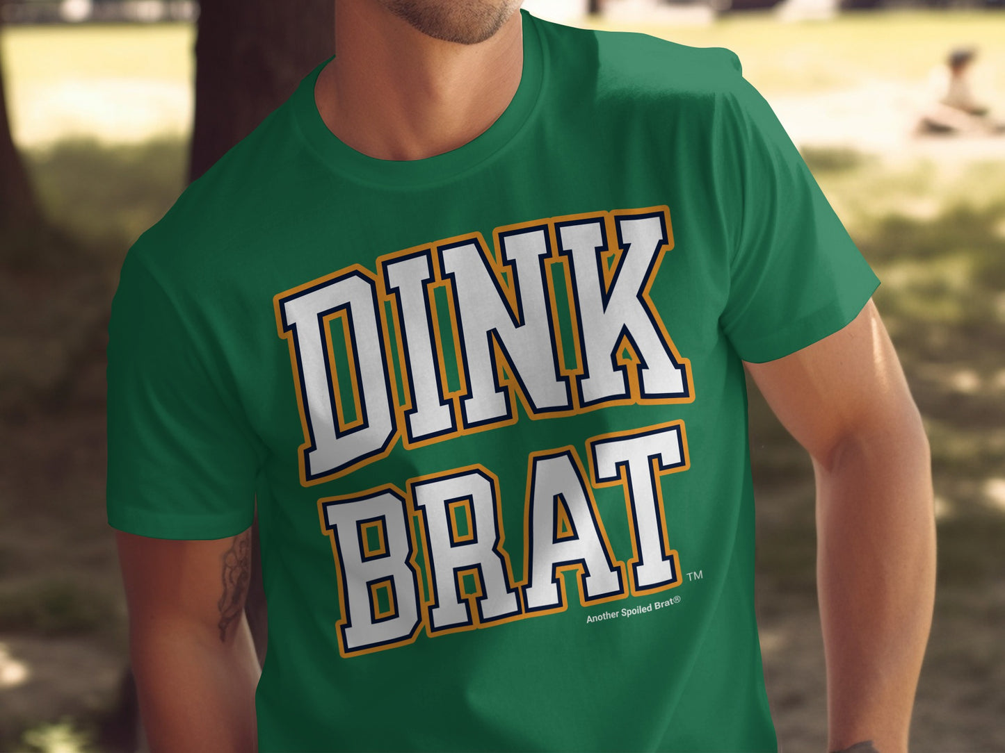 Green t-shirt with "DINK BRAT" text and "Another Spoiled Brat®" logo.