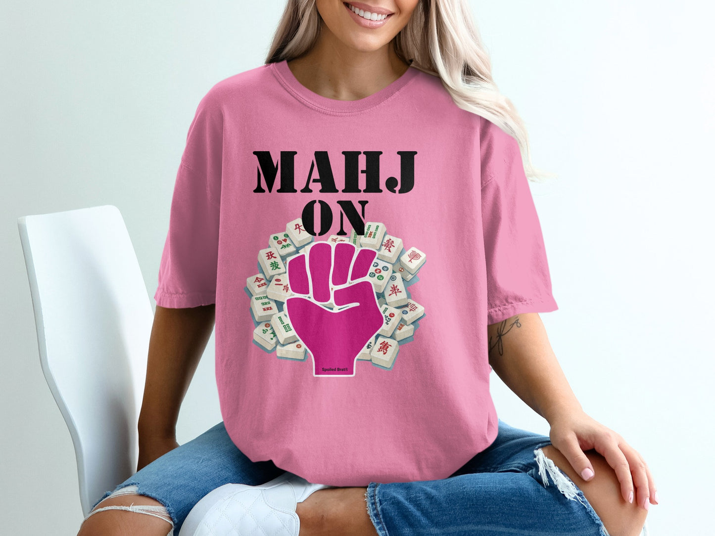 Pink t-shirt with "MAHJ ON" and a fist holding mahjong tiles.