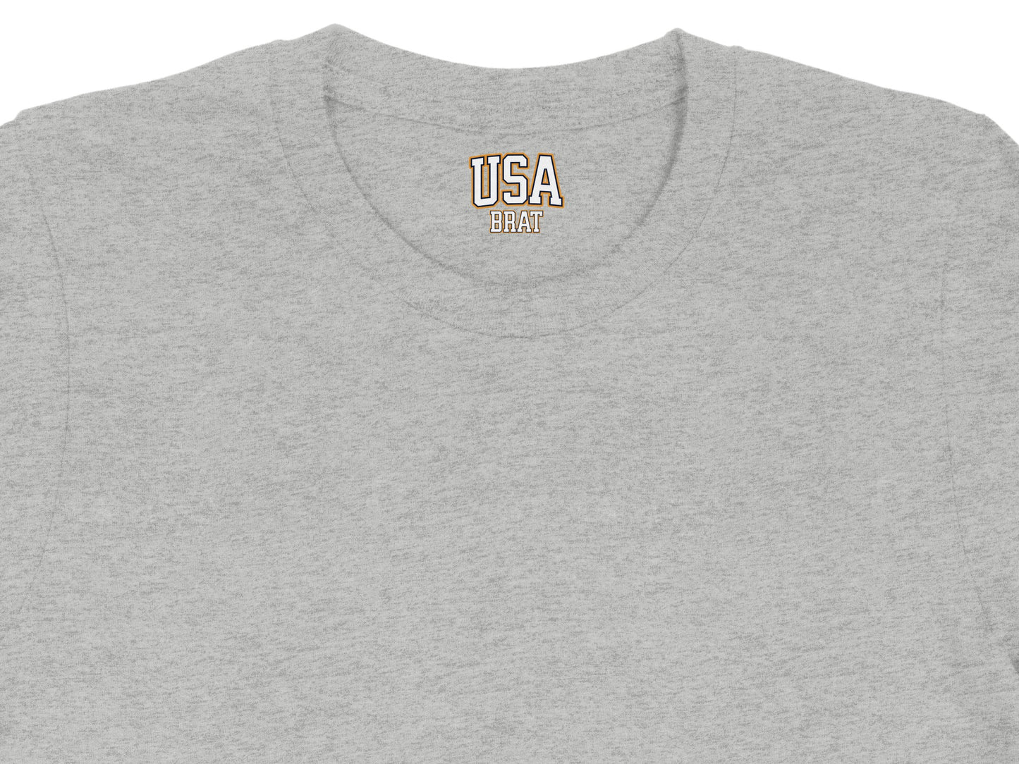 Grey t-shirt collar with embroidered USA BRAT text in orange and gold.