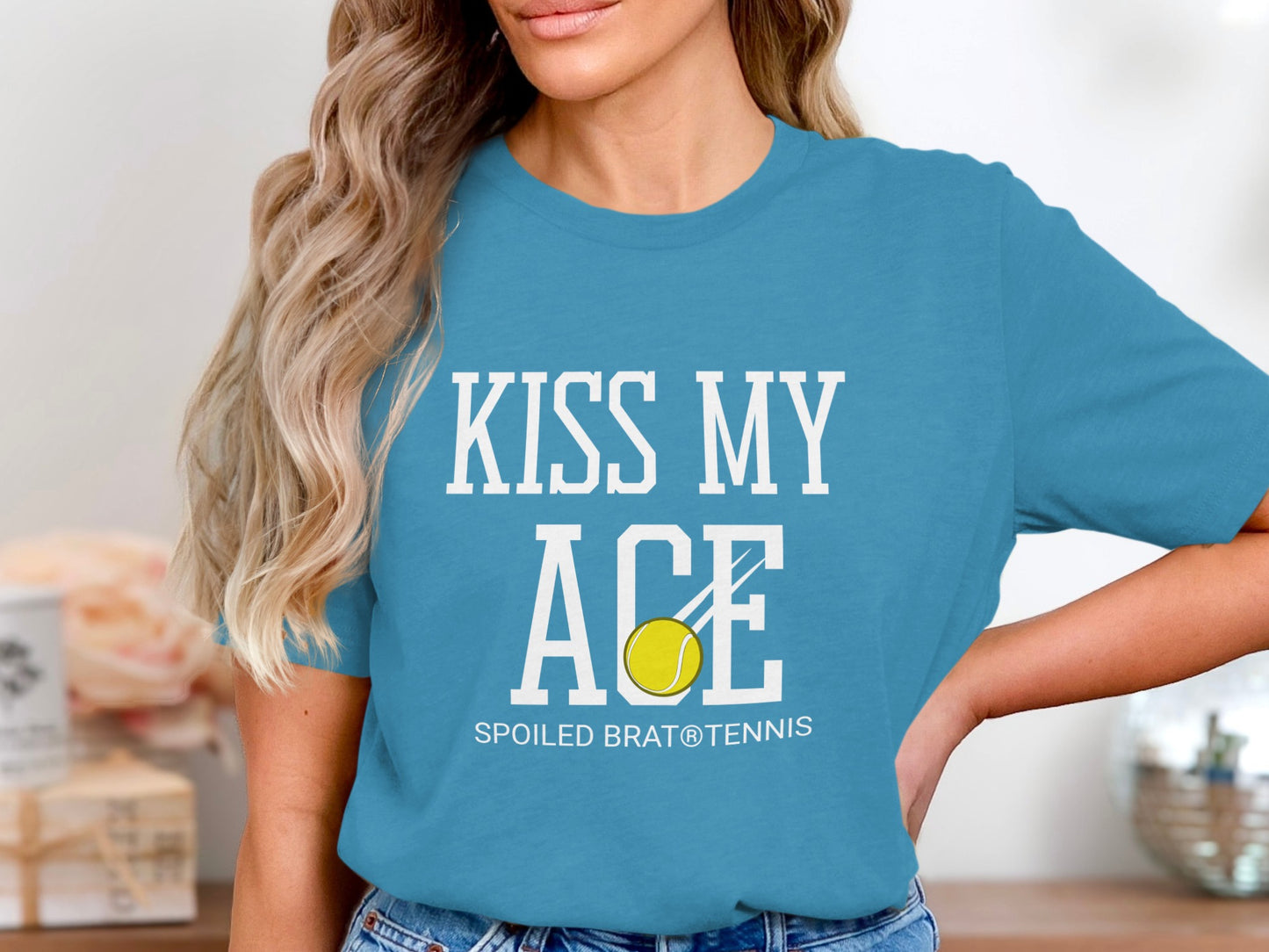 Blue t-shirt with "KISS MY ACE" and tennis ball, "SPOILED BRAT® TENNIS" below.