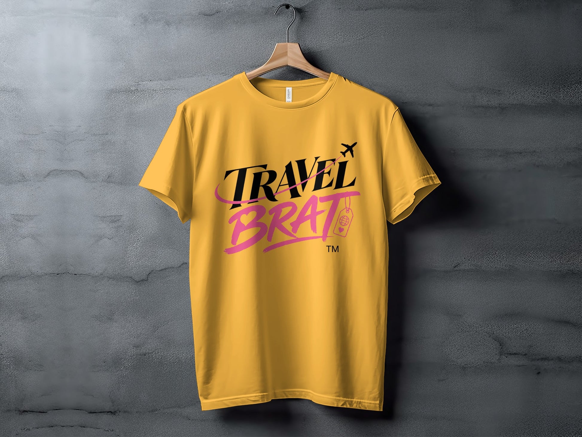 Yellow t-shirt with "Travel Brat" text and airplane graphic.