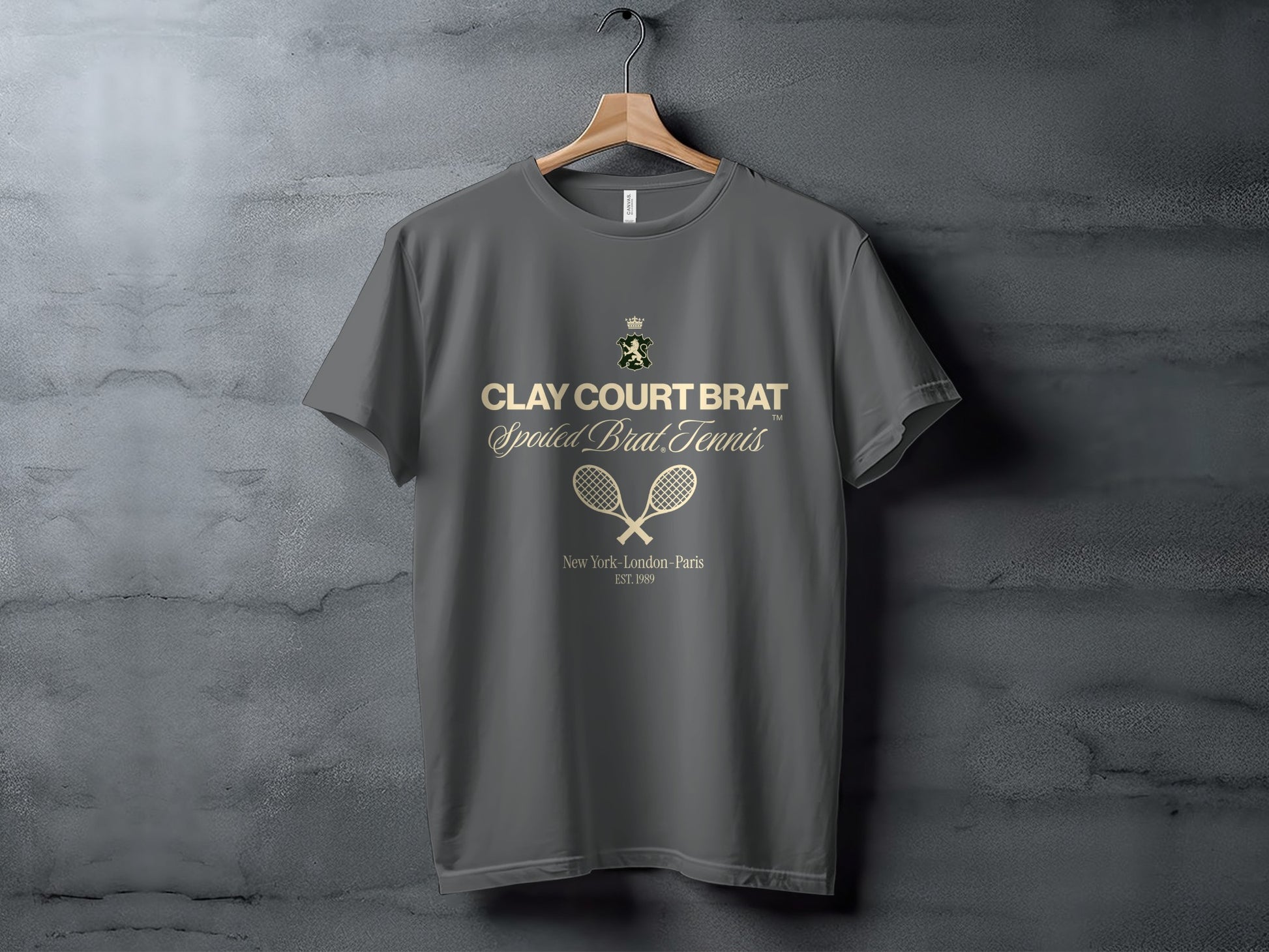Grey t-shirt with "Clay Court Brat Spoiled Brat Tennis" text and tennis rackets.