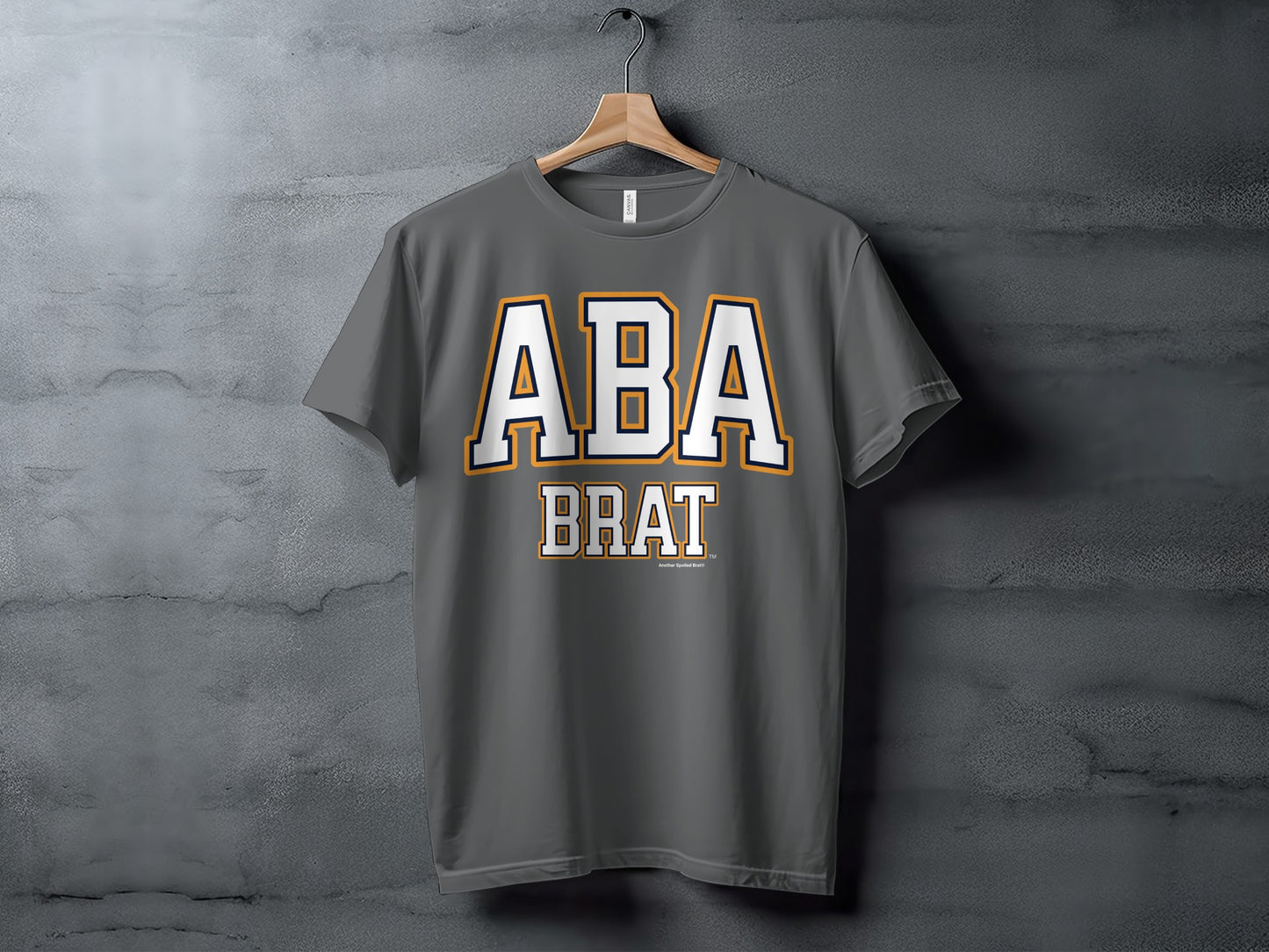 Dark gray t-shirt with "ABA BRAT" printed in white and orange.