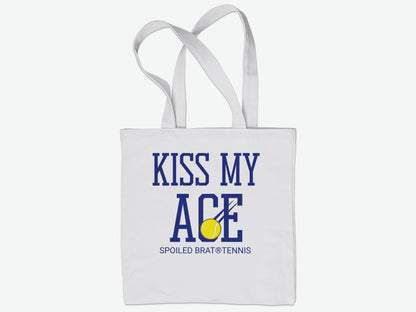 White tote bag with "KISS MY ACE" and tennis ball graphic.