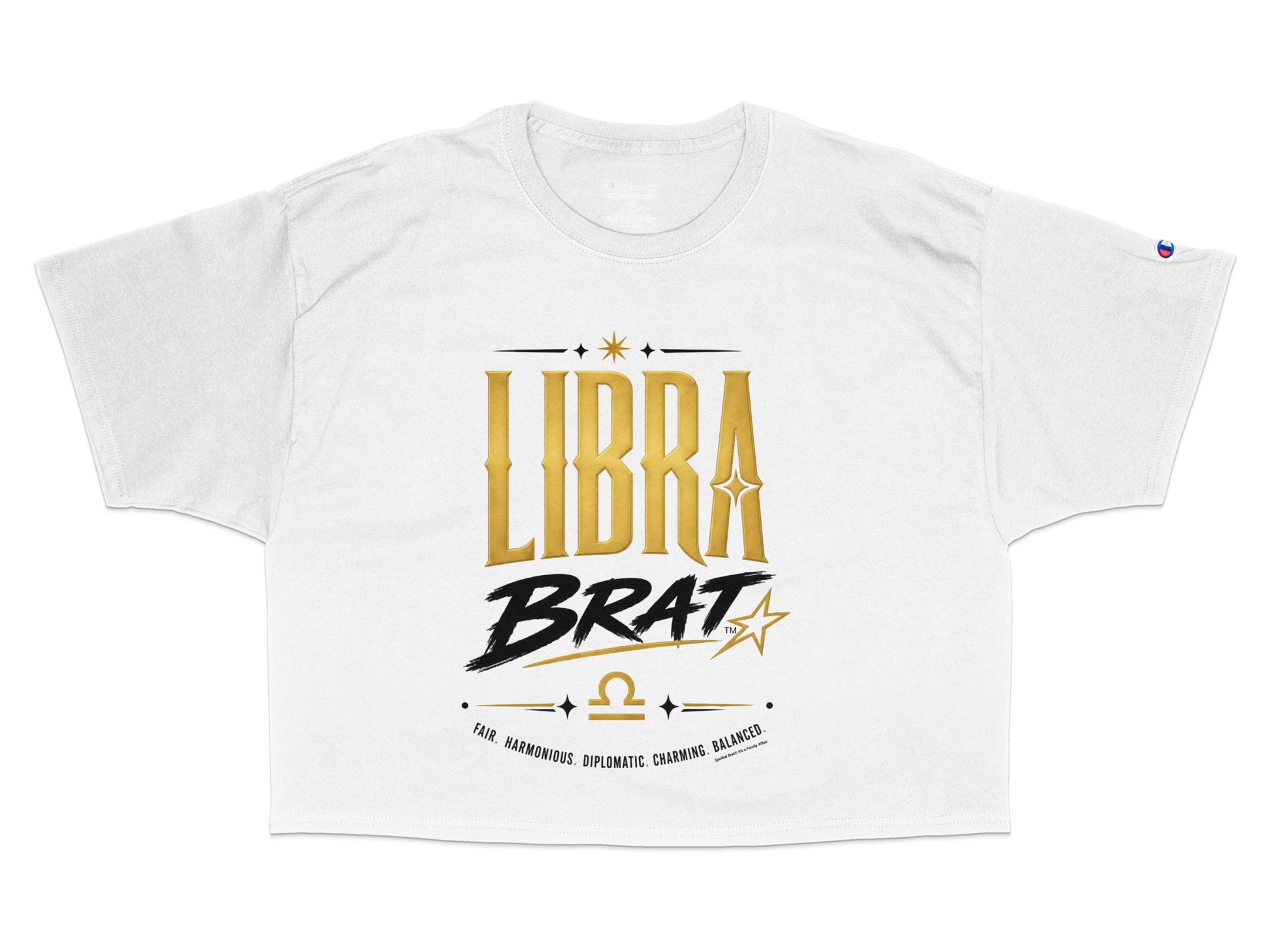 White cropped t-shirt featuring "LIBRA BRAT" in gold and black with Libra symbol and descriptive words.