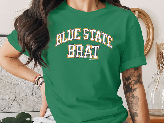 Green t-shirt with white and gold text reading "BLUE STATE BRAT"