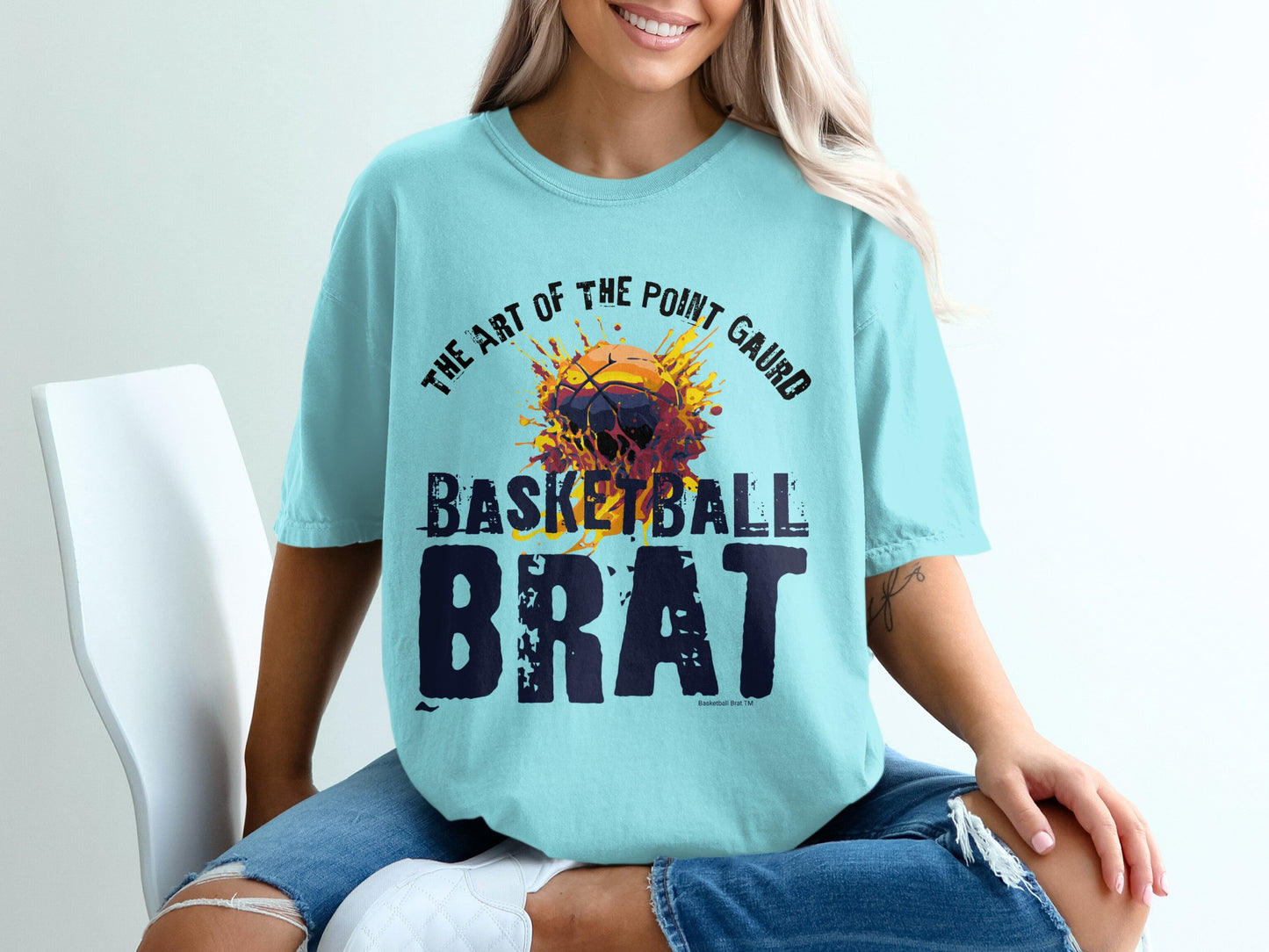 Light blue t-shirt with "The Art of the Point Guard Brat" basketball graphic.