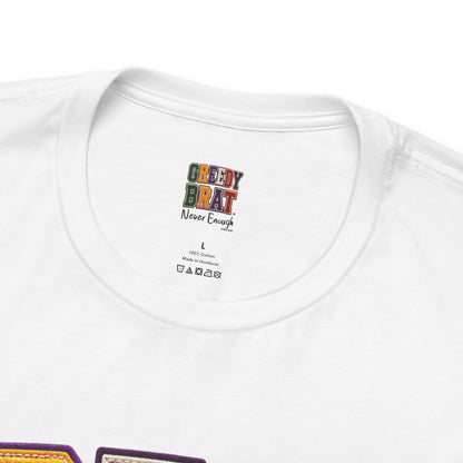 White t-shirt with "GREEDY BRAT Never Enough" graphic and size/care labels.