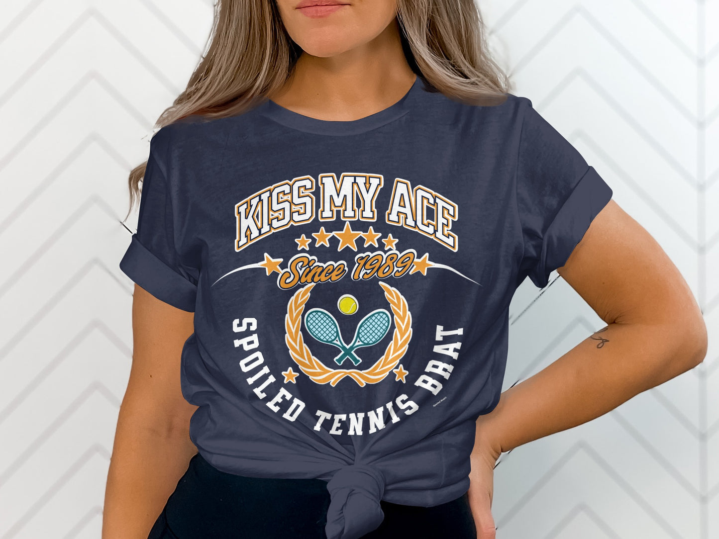Navy t-shirt with "Kiss My Ace Since 1989" and tennis graphics.