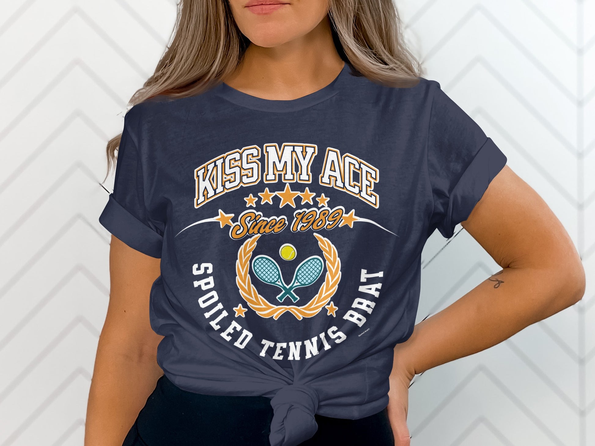 Navy t-shirt with "Kiss My Ace Since 1989" and tennis graphics.
