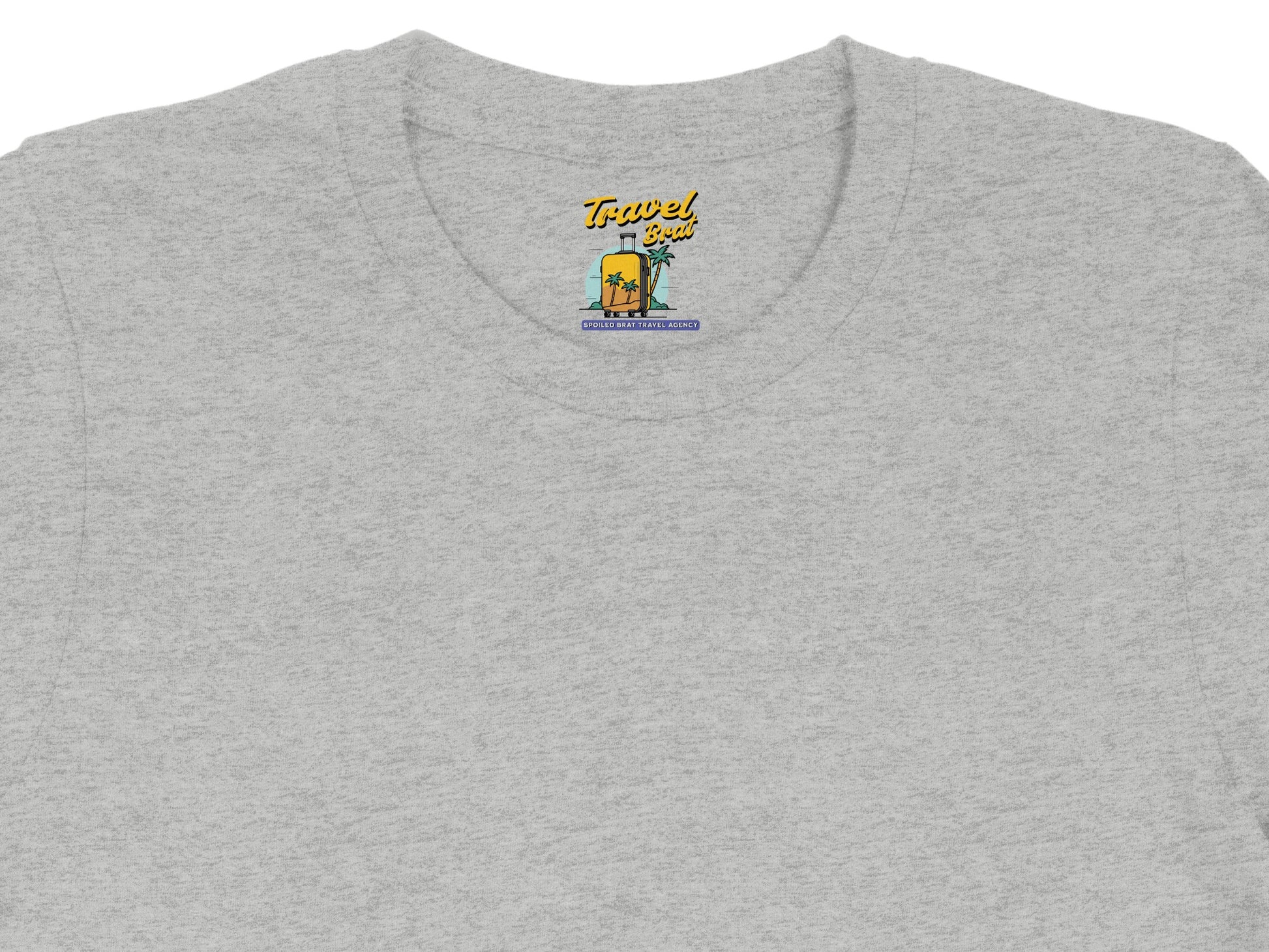 Light grey t-shirt with "Travel Brat" logo featuring a suitcase and palm trees.