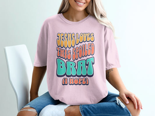 Pink t-shirt with "JESUS LOVES THIS SPOILED BRAT (I HOPE)" text.
