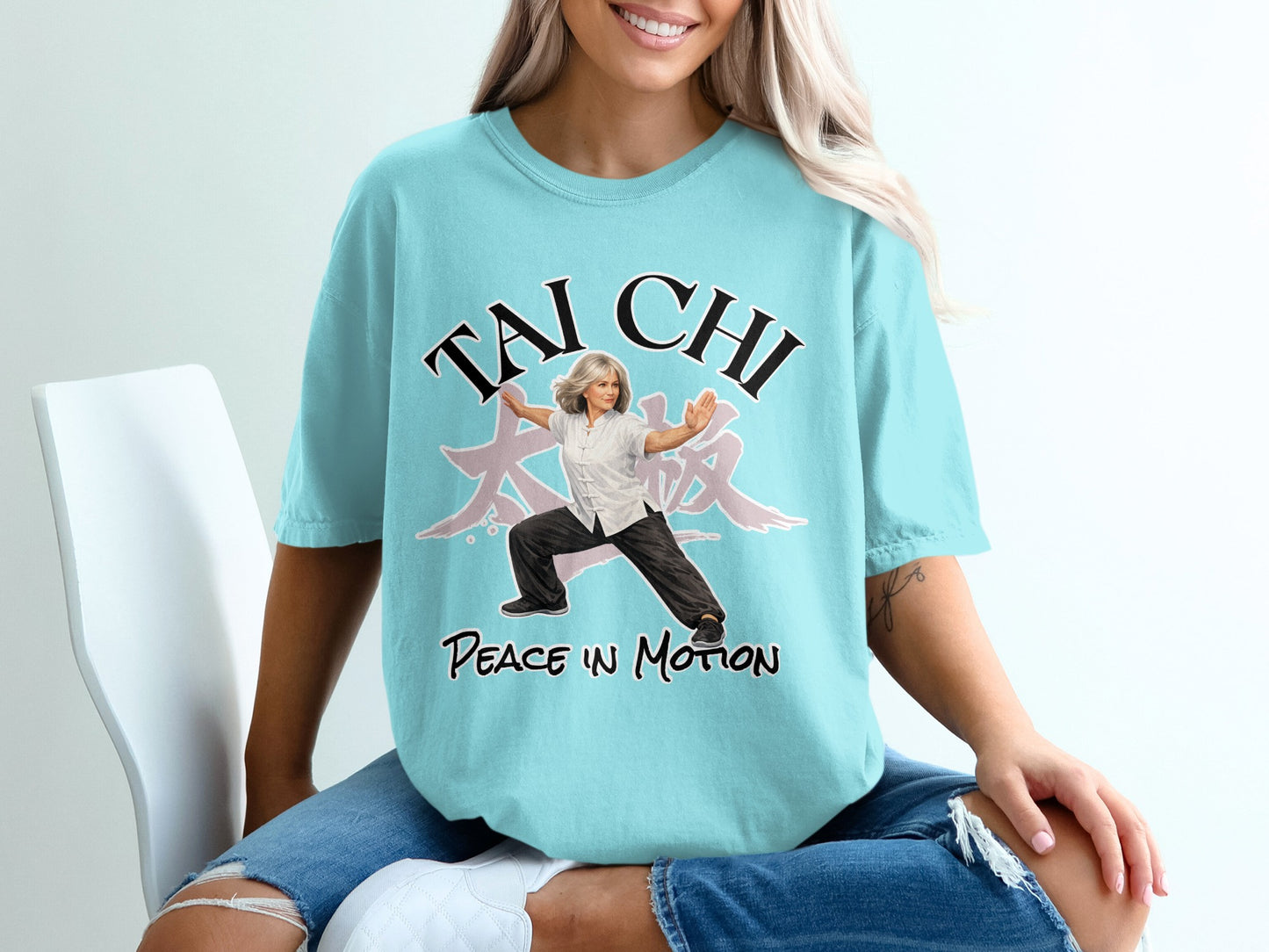 Woman in t-shirt with "Tai Chi Peace in Motion" text and a martial artist graphic.