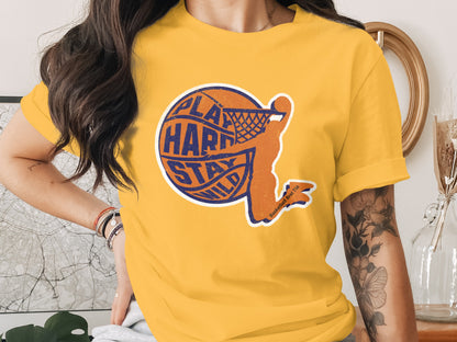 Orange basketball player silhouetted with text "Play Hard Stay Wild" on yellow t-shirt.