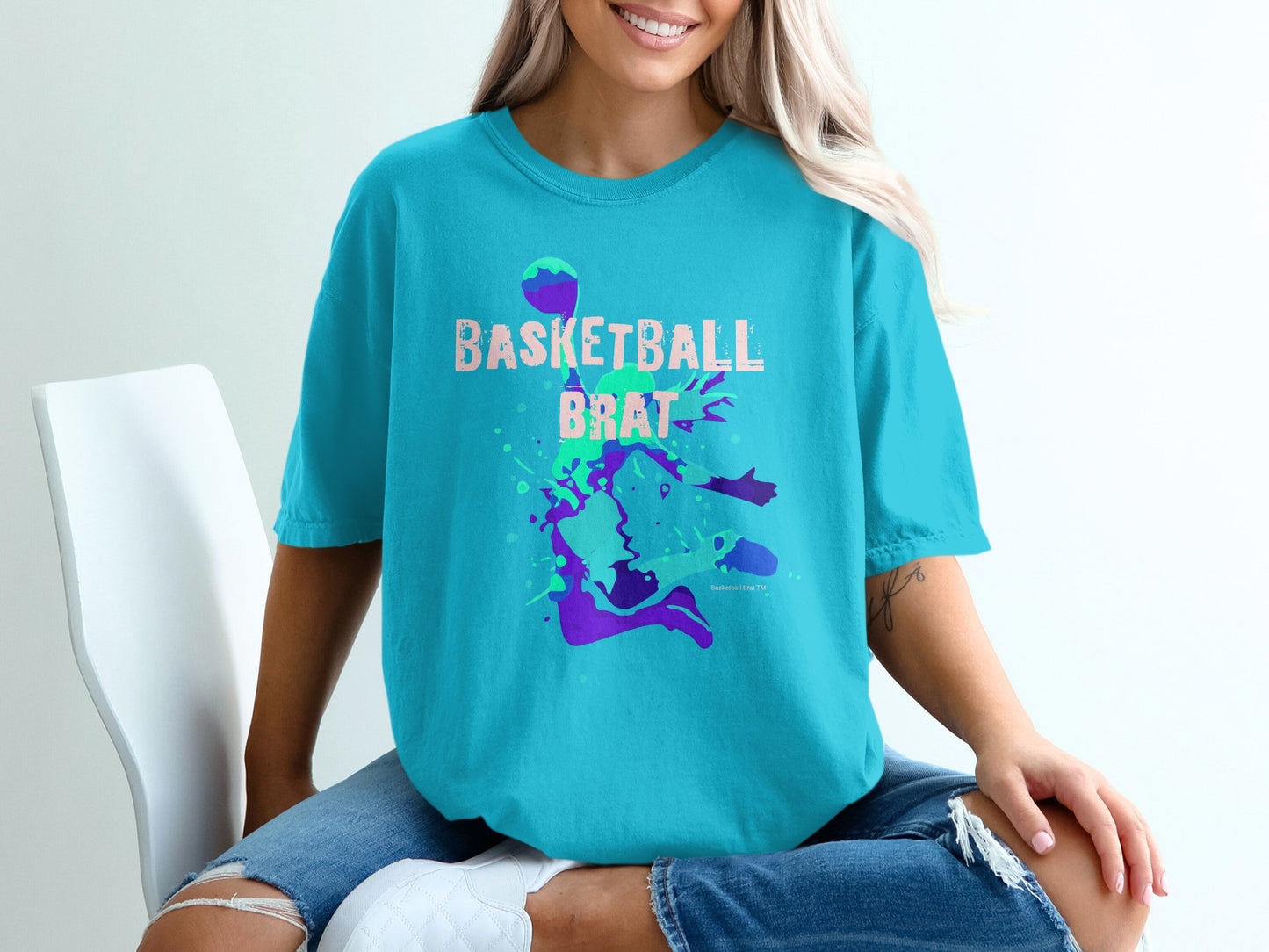 Turquoise t-shirt with "Basketball Brat" graphic and basketball silhouette.