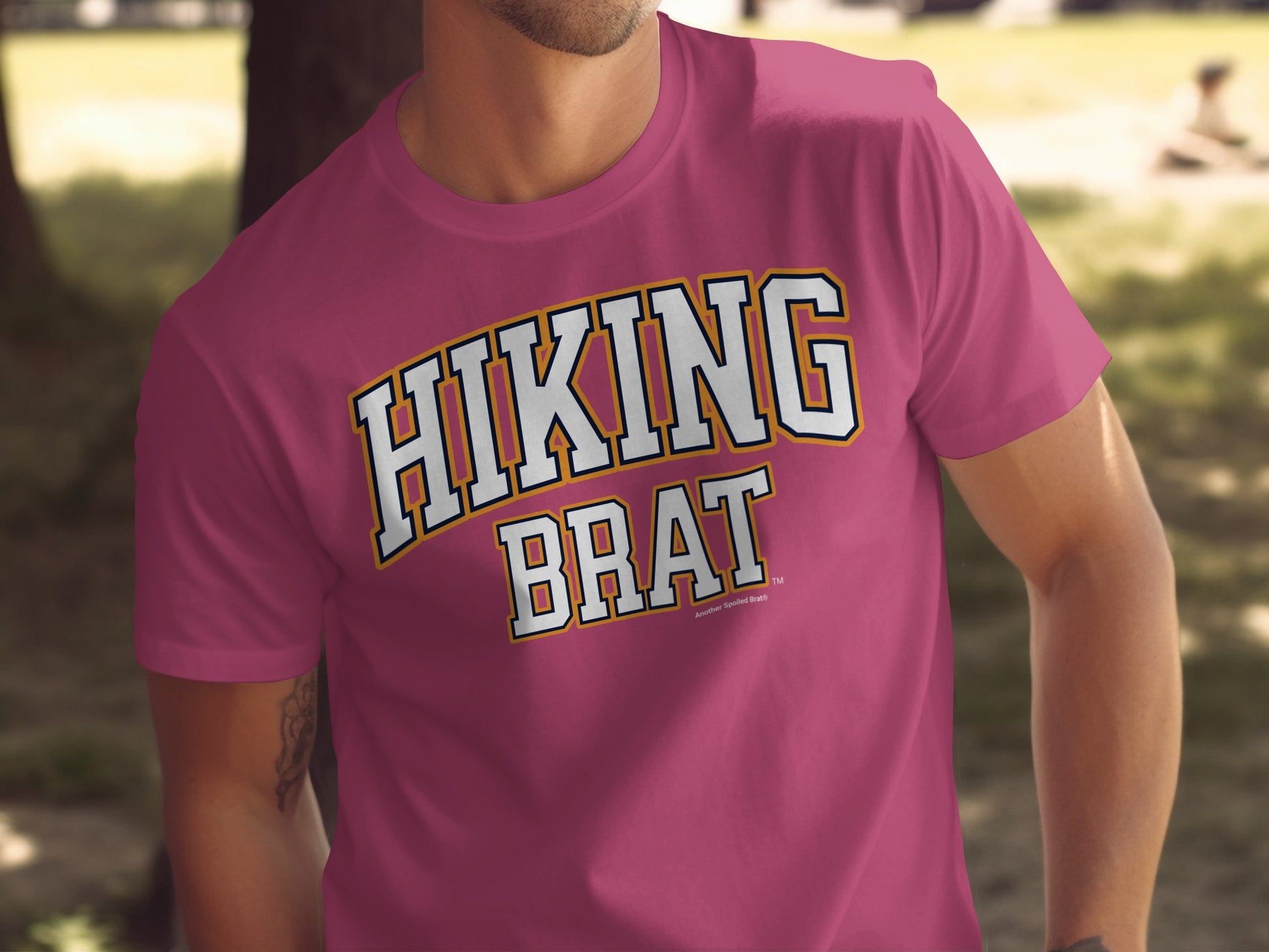 Maroon t-shirt with "HIKING BRAT" in white and gold collegiate text.