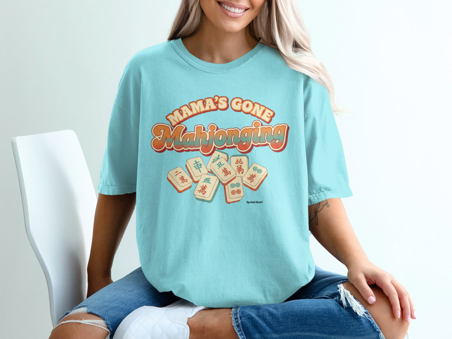 Teal t-shirt with "Mama's Gone Mahjong" text and mahjong tiles.