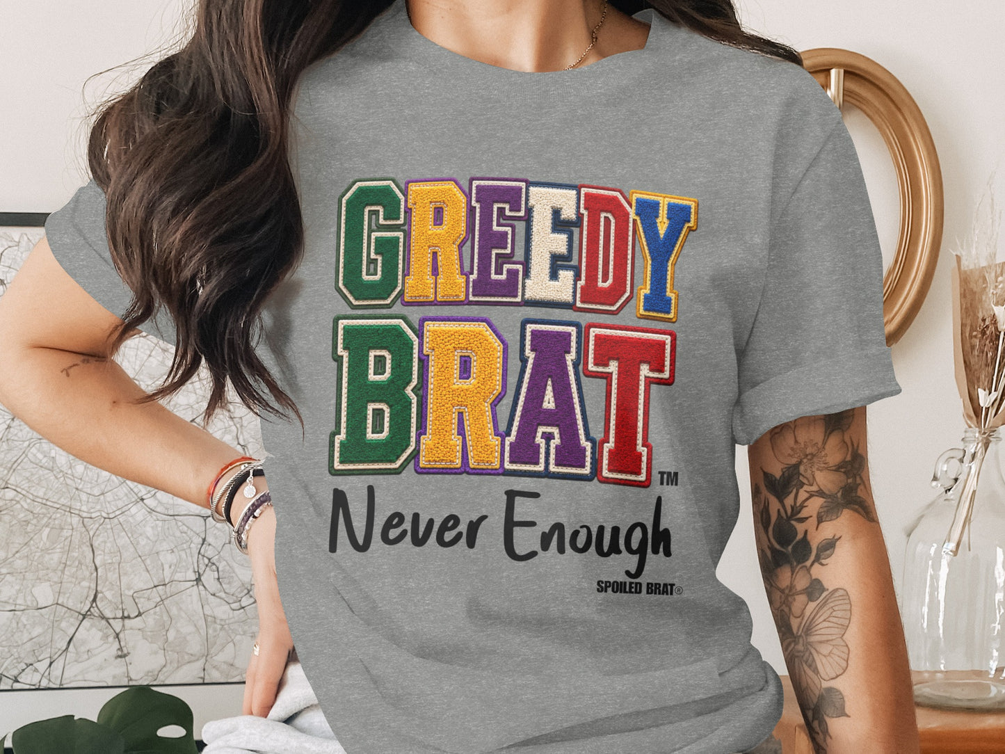 Gray t-shirt, "GREEDY BRAT" and "Never Enough" text, Spoiled Brat logo.