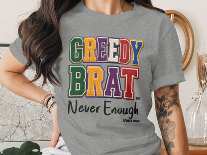 Gray t-shirt, "GREEDY BRAT" and "Never Enough" text, Spoiled Brat logo.