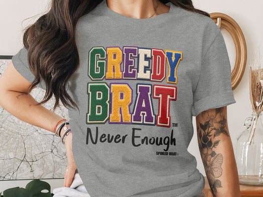 Gray t-shirt, "GREEDY BRAT" and "Never Enough" text, Spoiled Brat logo.