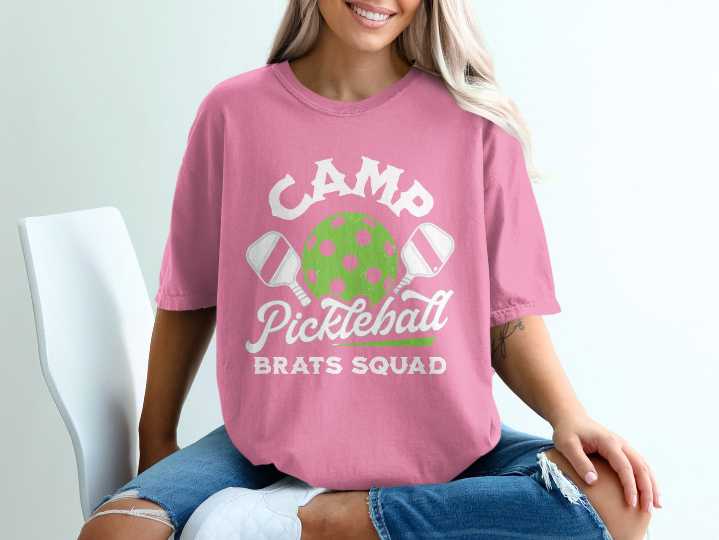 Pink t-shirt with "CAMP Pickleball BRATS SQUAD" text and pickleball graphic.