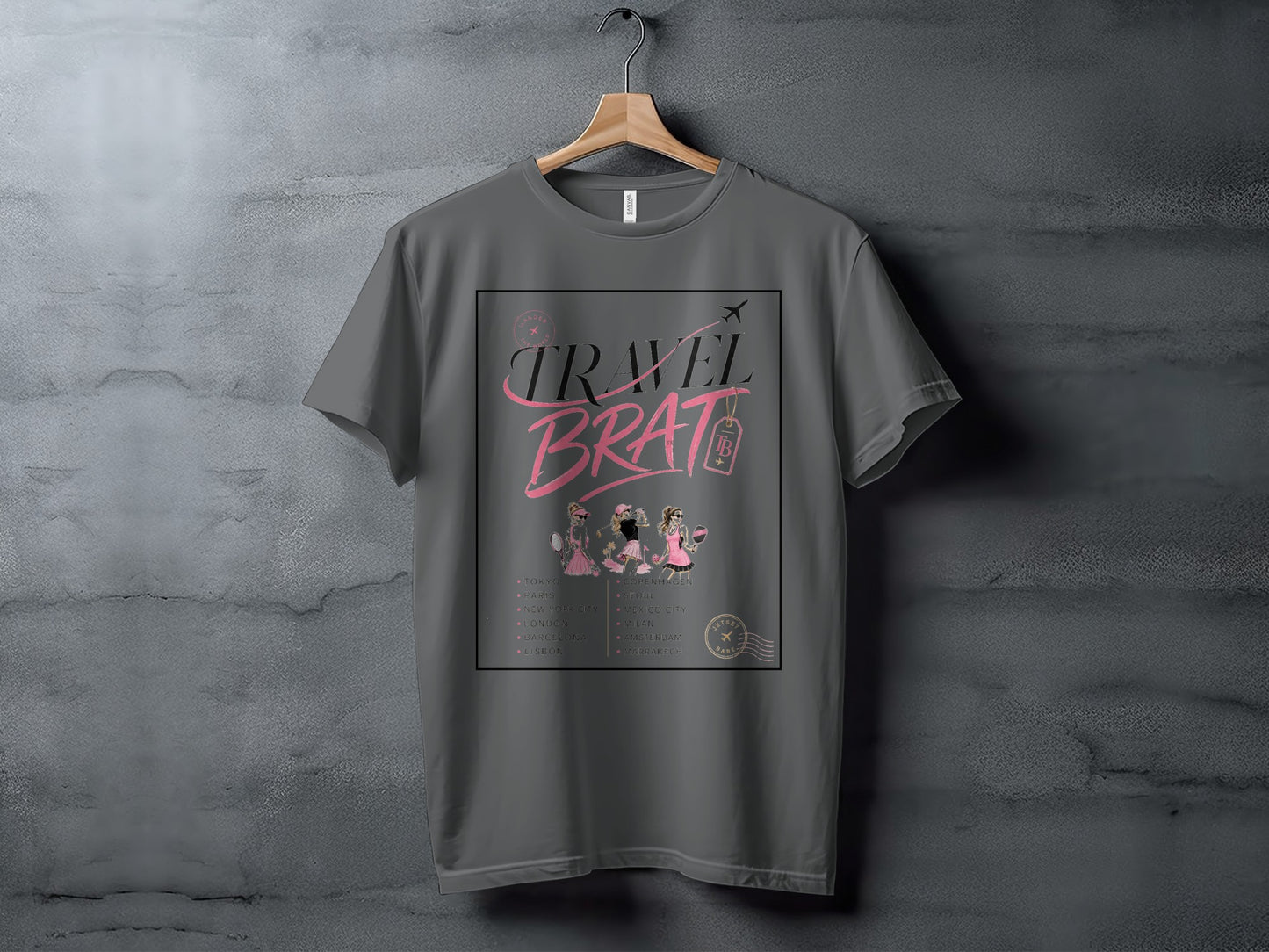 Grey t-shirt with "TRAVEL BRAT" text, travel destinations, and three stylized women.