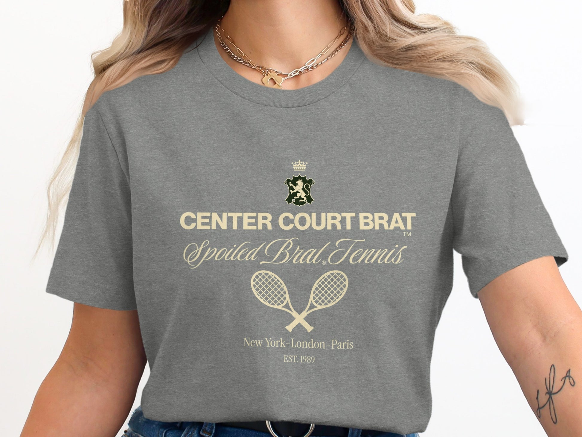 Grey t-shirt with "CENTER COURT BRAT" tennis racket graphic and text.