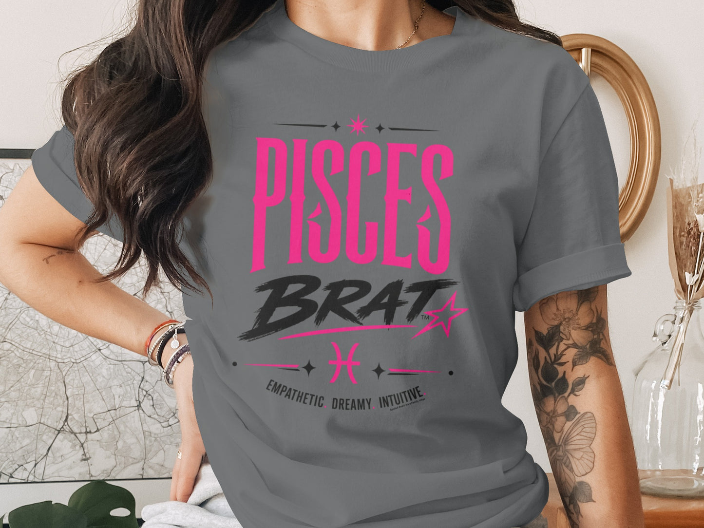 Gray t-shirt with "PISCES BRAT" text, Pisces symbol, and traits.
