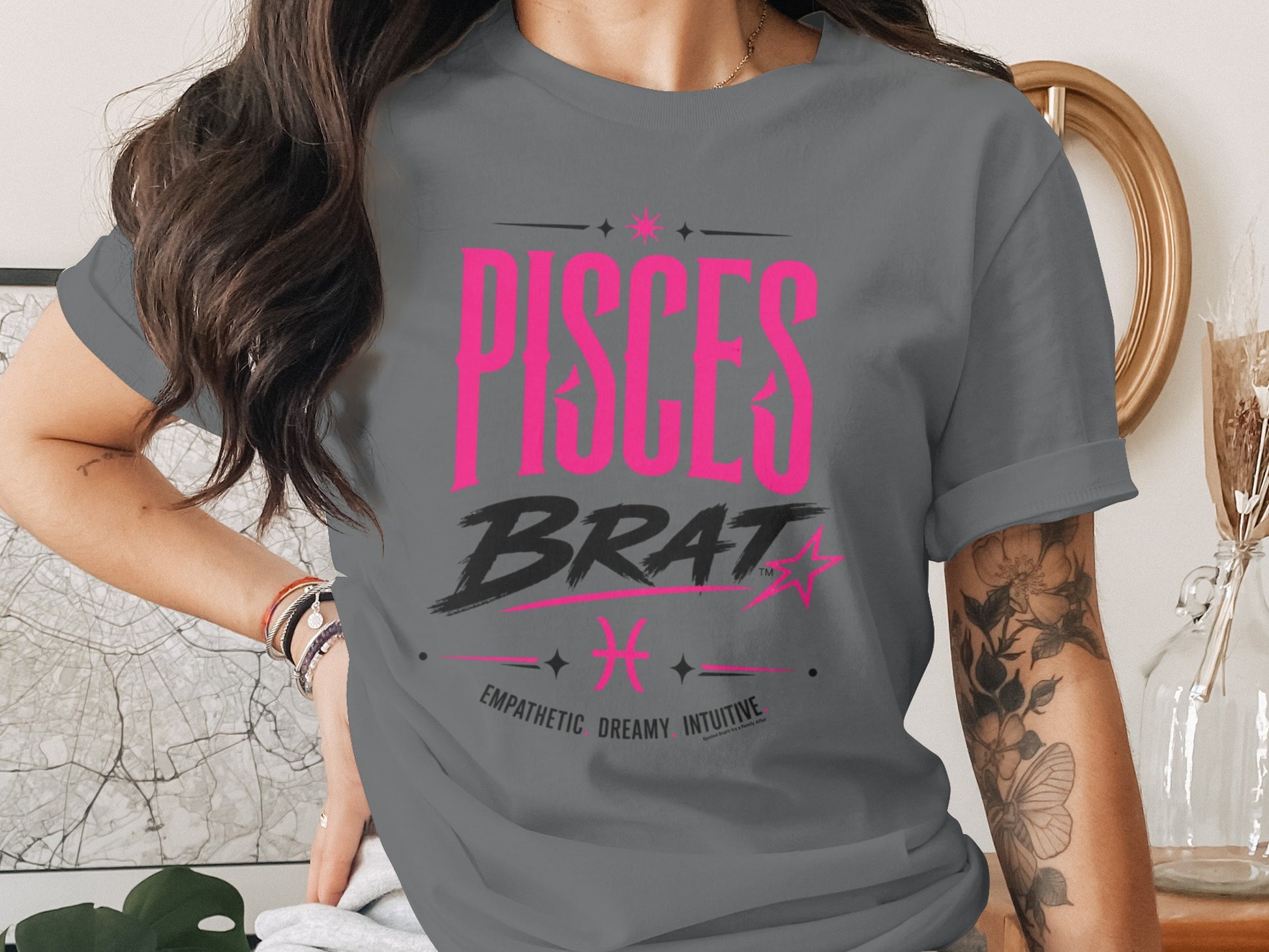Gray t-shirt with "PISCES BRAT" text, Pisces symbol, and traits.