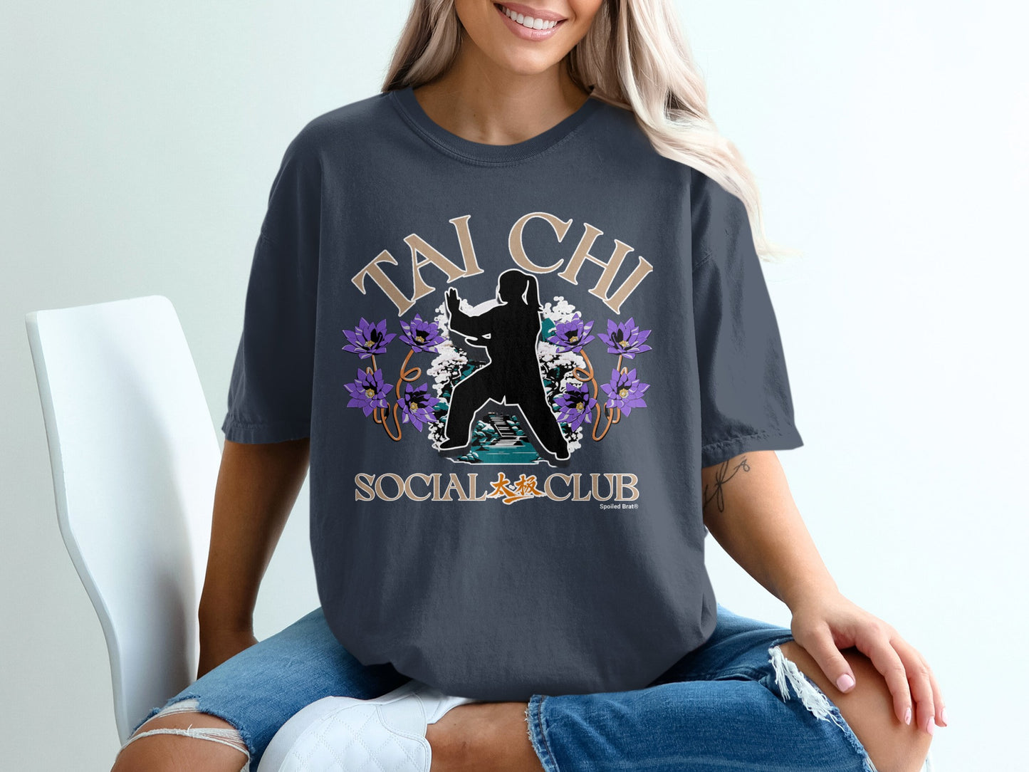 Dark t-shirt with "Tai Chi Social Club" text and floral silhouette.