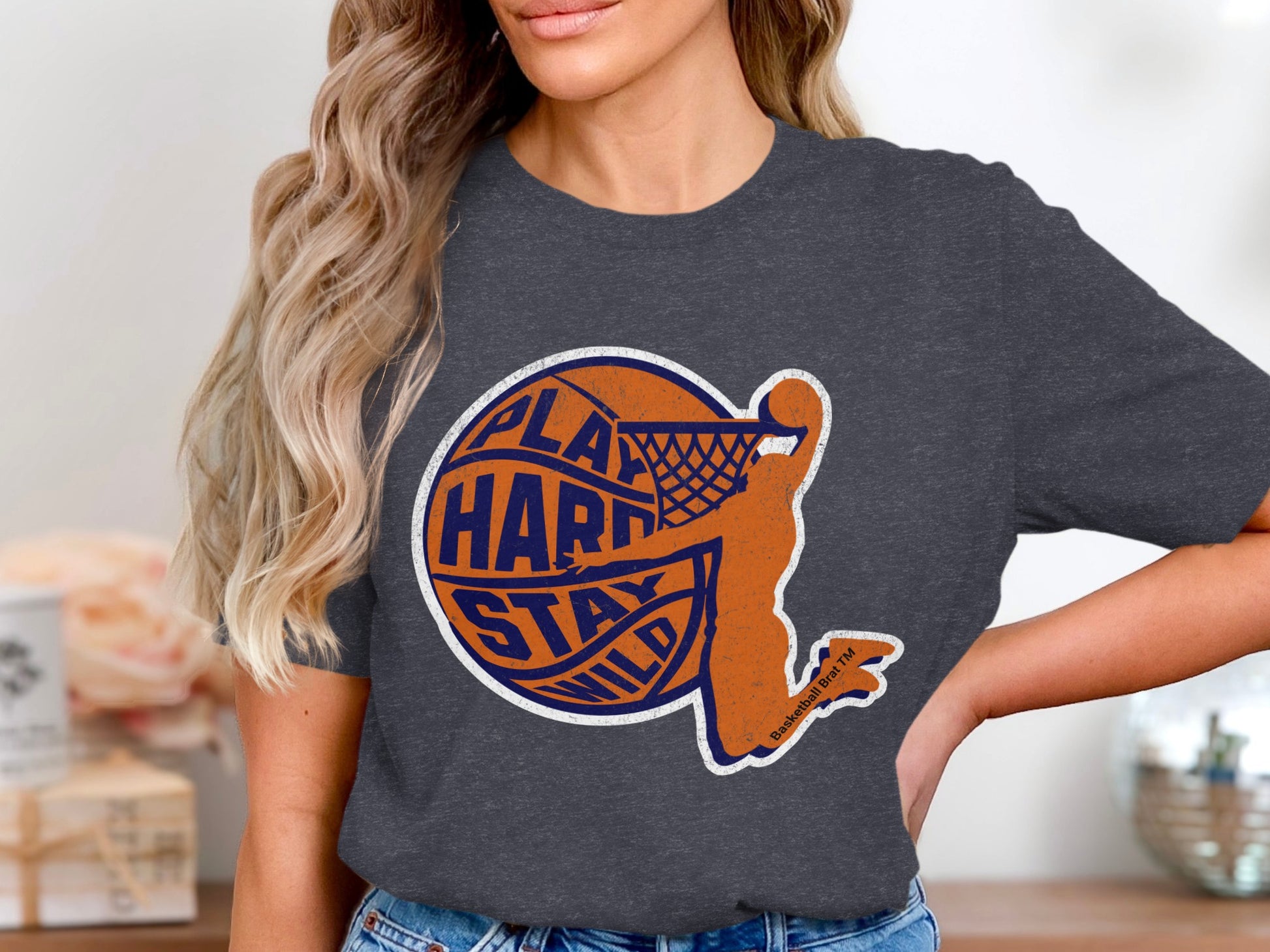 Dark grey t-shirt with orange basketball player and text "play hard stay wild".