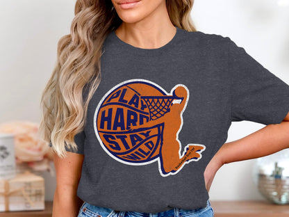 Dark grey t-shirt with orange basketball player and text "play hard stay wild".