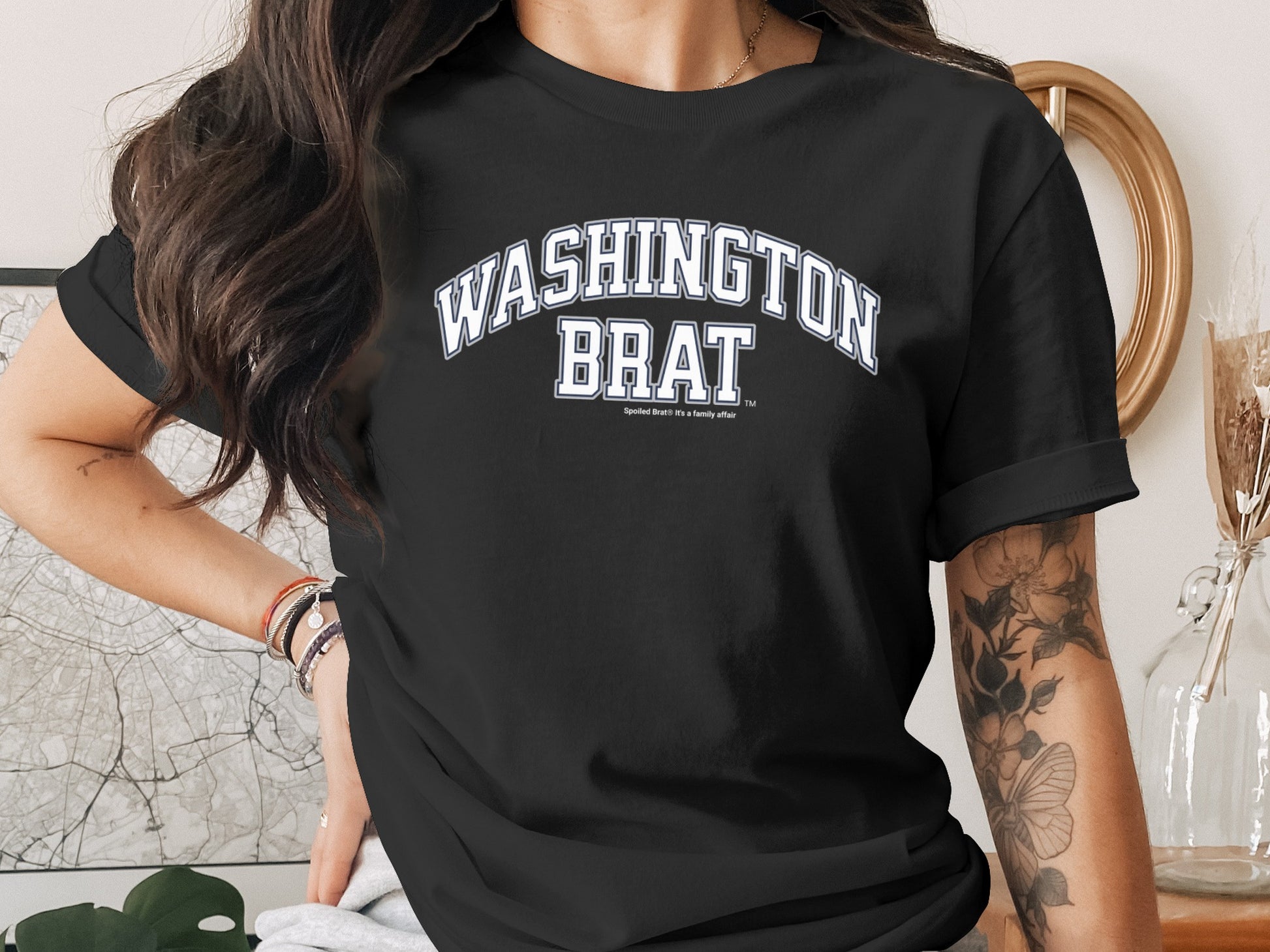 Black t-shirt with "WASHINGTON BRAT" in white arched letters.